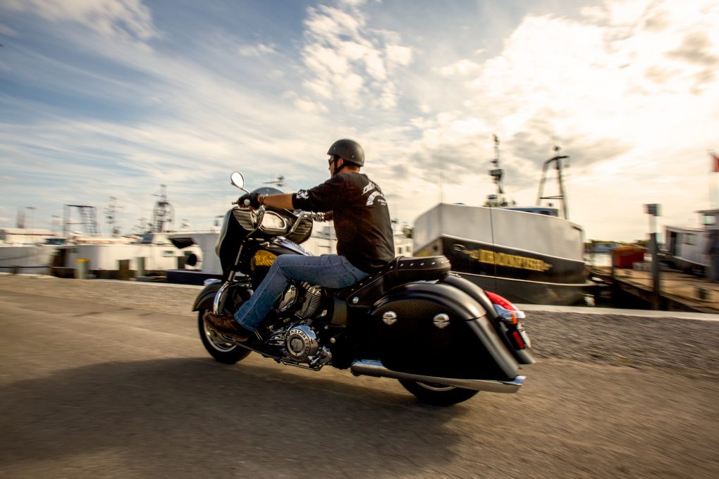 Motorcycle traveling past harbour