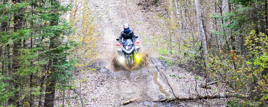 Adventure motorcycle riding through a mud hole