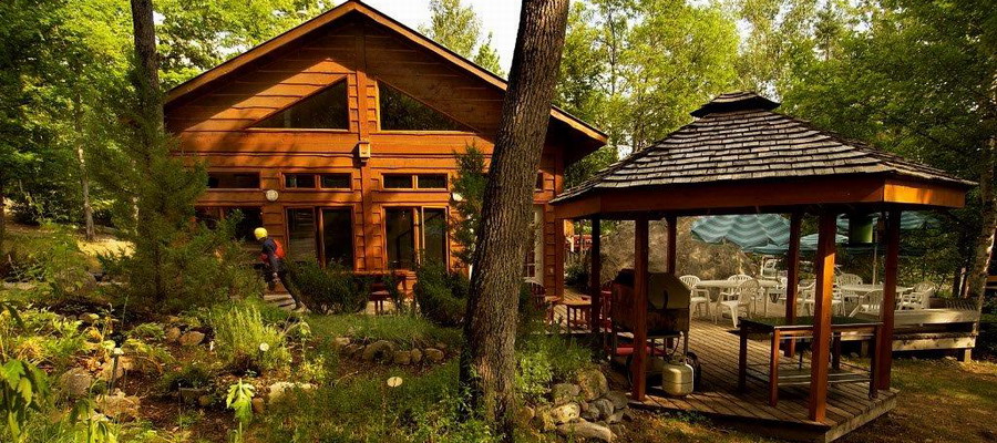 wood sided chalet and gazebo in forest