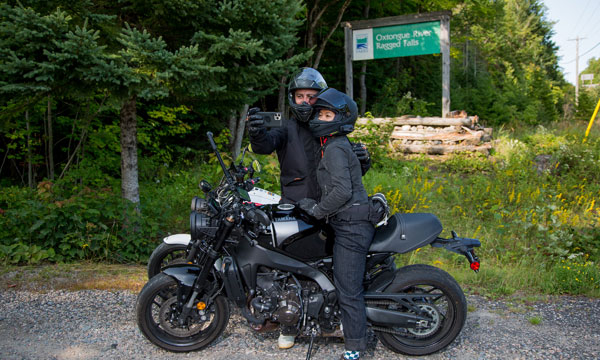  Motorcycle riders in front of sign