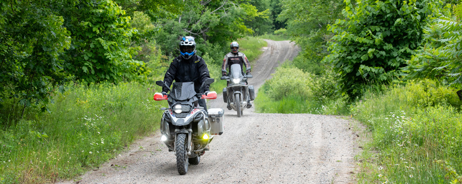 Two adventure motorcycles on gravel road